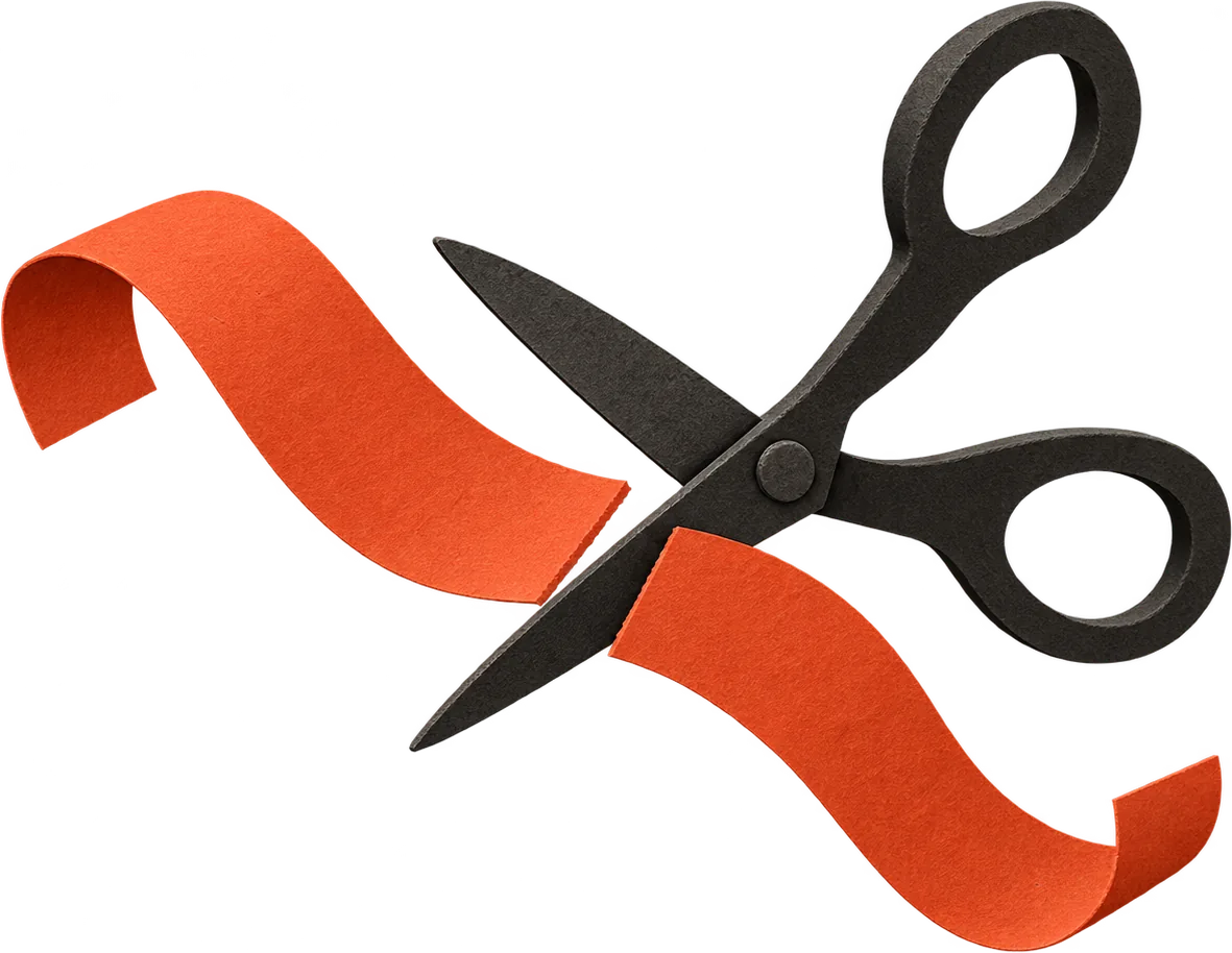 Black paper scissors cutting a strip of red paper tape